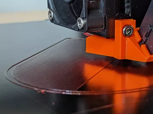A 3D printer laying down its first layer